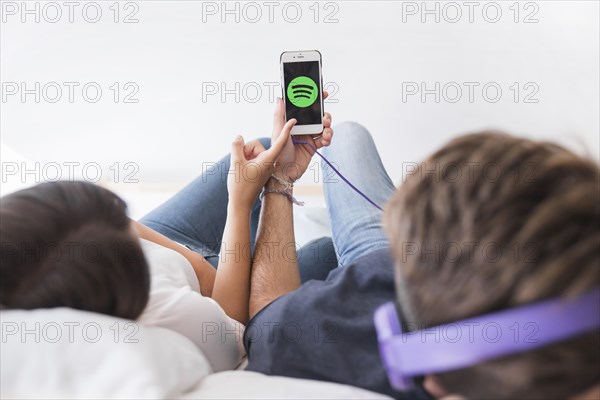 Young couple listening music with spotify app