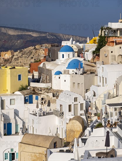 Blue-domed Church of Agios Nikolaos and caldera houses