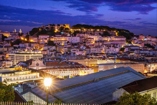 View of Lisbon famous view from Miradouro de Sao Pedro de Alcantara tourist viewpoint in the evening. Lisbon