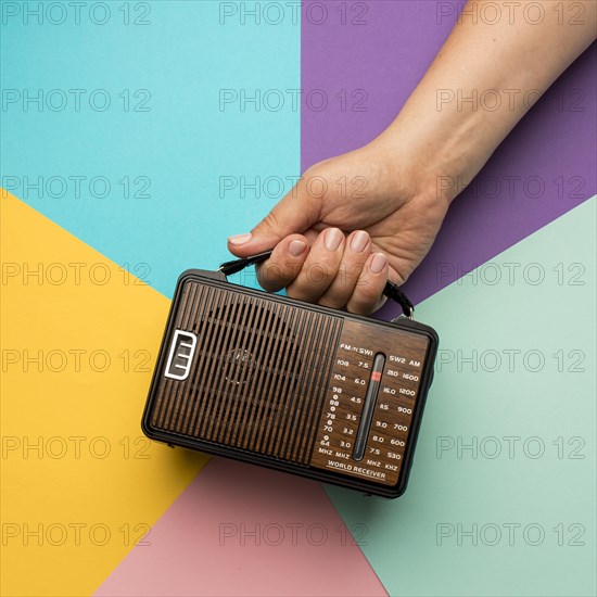 Person holding retro broadcast radio receiver