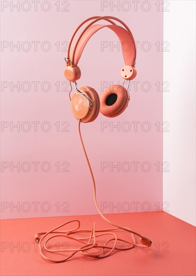 Pink headphones with cable flying