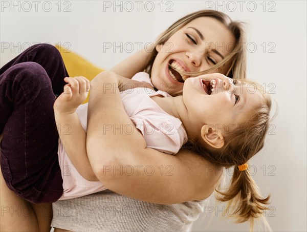 Beautiful mother spending time together with her daughter home