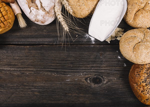 Overhead view flour shovel with baked breads table