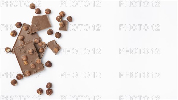 Top view chocolate with hazelnuts copy space