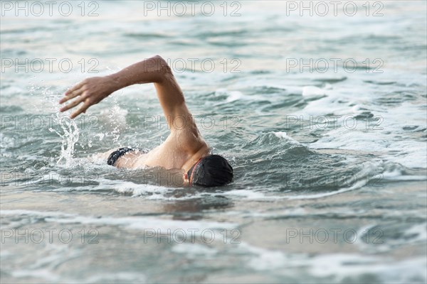 Male swimmer swimming ocean
