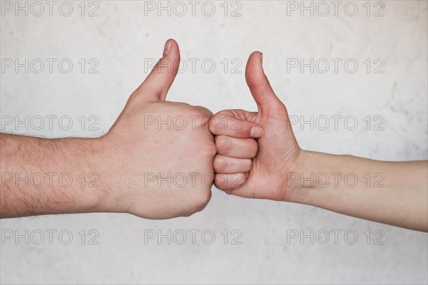 Hands showing thumb up sign