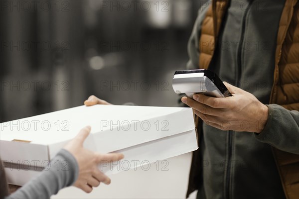 Delivery man with mask client paying