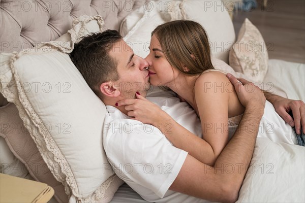 Romantic couple kissing bed
