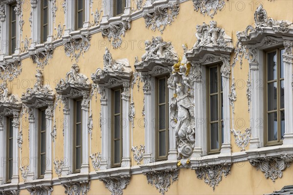 Windows of the Falcon House with stucco facade and rococo-style sculptures in the centre of Wuerzburg