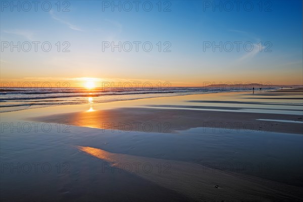 Atlantic ocean sunset with surging waves at Fonte da Telha beach