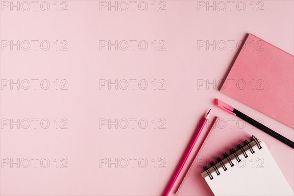 Pink office supplies colored surface