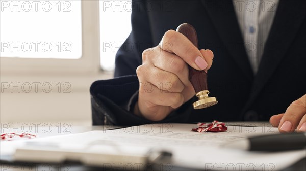 Person using wax seal certificate