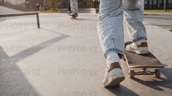 Back view teenager with skateboard copy space skatepark