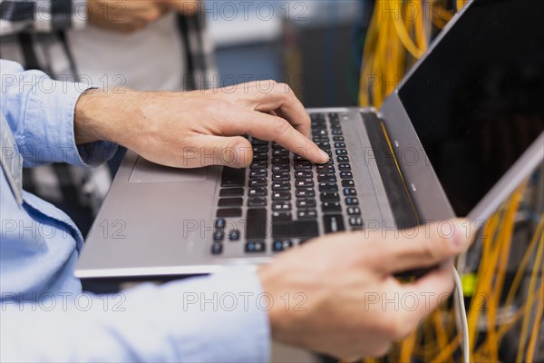 Person typing laptop close up