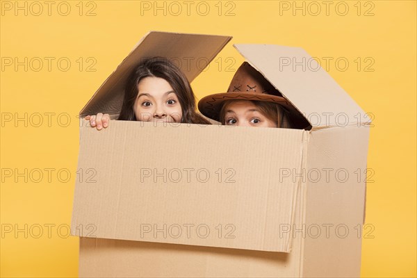 Girls hiding cartoon box