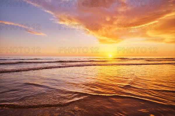 Atlantic ocean sunset with surging waves at Fonte da Telha beach