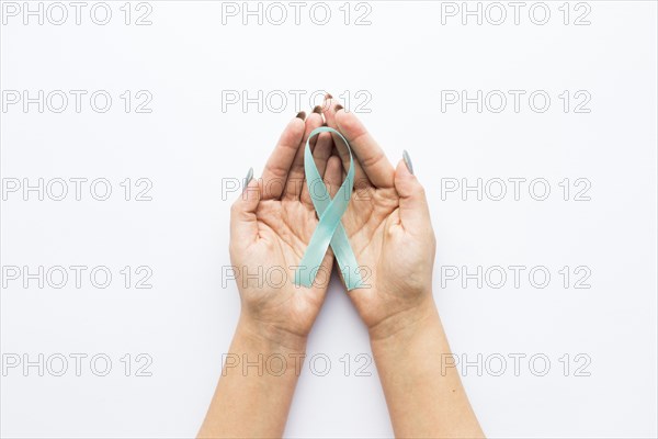 Light blue ribbon crop hands