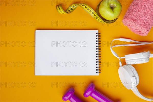 Flat lay notebook apple yellow background