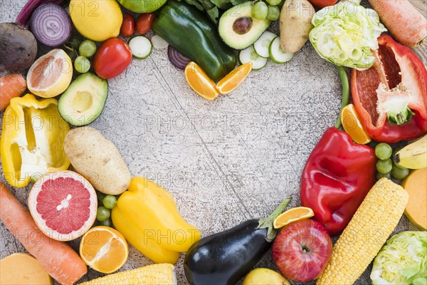 Heart shape made with colorful vegetables textured backdrop