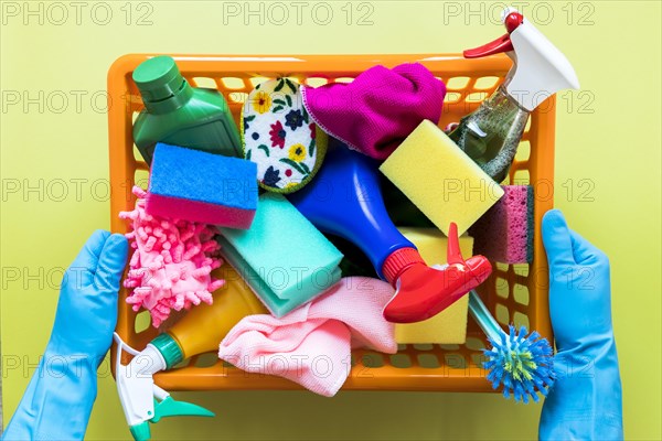 Close up person holding basket with cleaning products