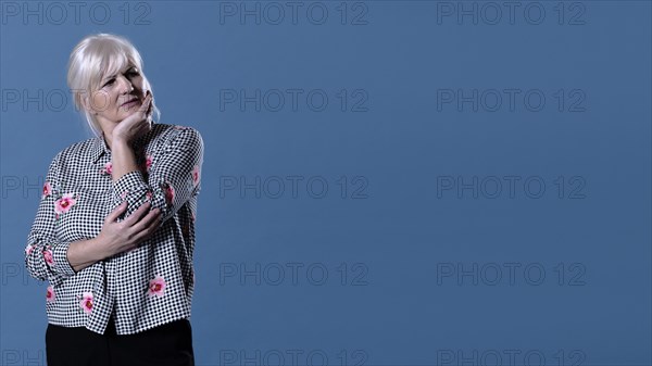 Elderly woman thinking with copyspace