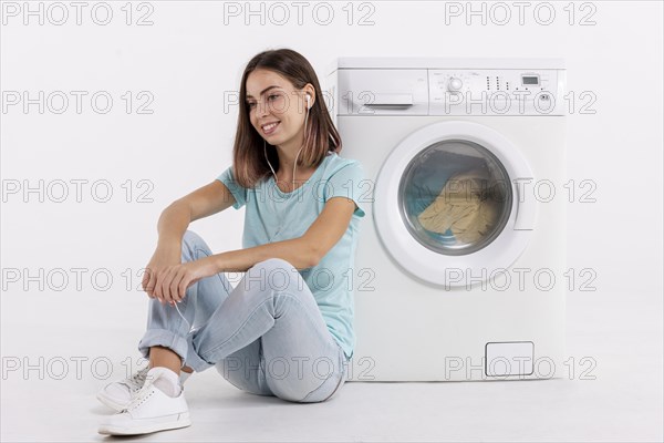 Woman listening music doing laundry