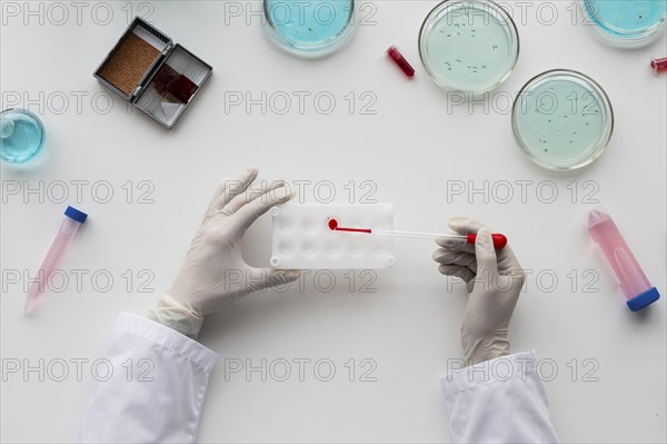 Close up scientist holding pipette