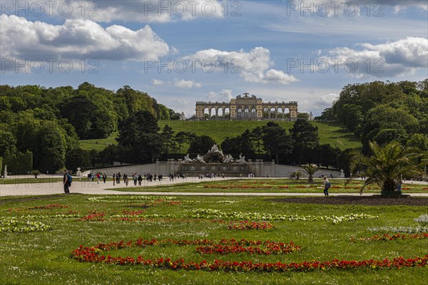 Schoenbrunn Palace Park with flower meadow Neptune Fountain and Gloriette