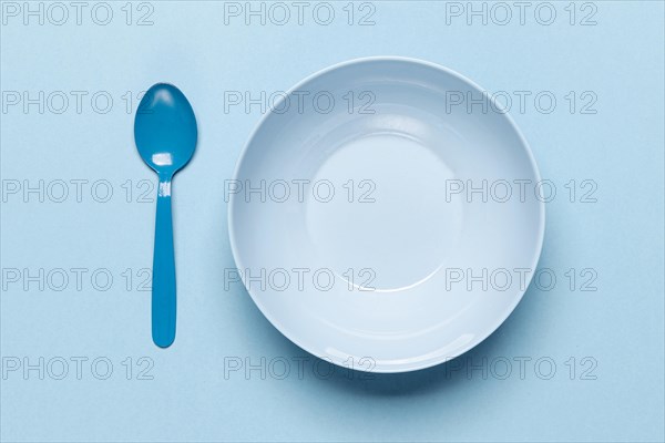 Top view empty blue bowl spoon