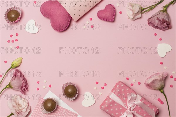 Flowers near hearts present box chocolate candies