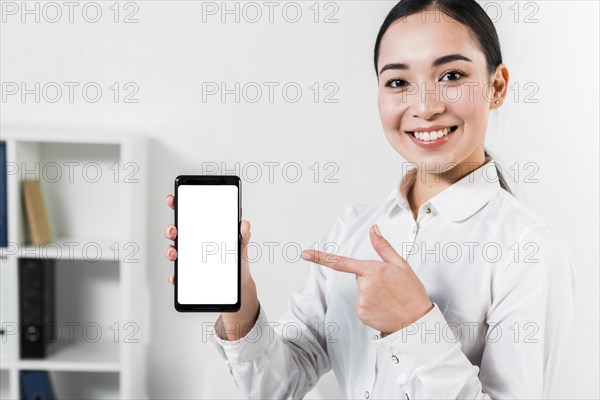 Portrait happy asian young businesswoman pointing mobile phone