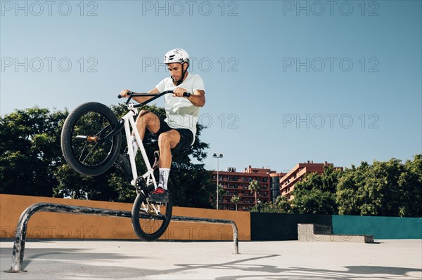 Teenage bmx rider performing tricks skatepark