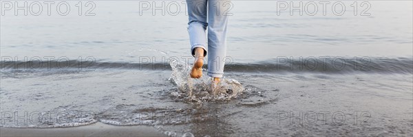 Woman getting into sea