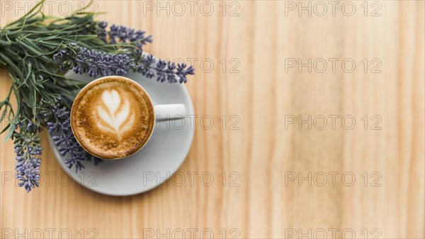 Coffee latte with lavender flower wooden surface