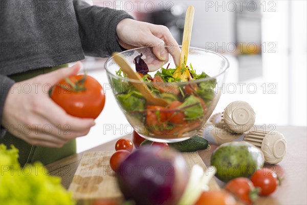 Hand holding bowl salad