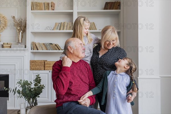 Medium shot happy family indoors