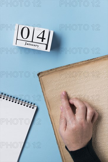 Close up hand reading braille alphabet