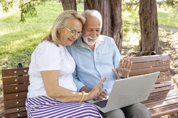 Couple greeting someone laptop