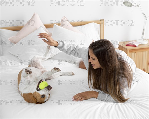 Full shot girl playing with dog