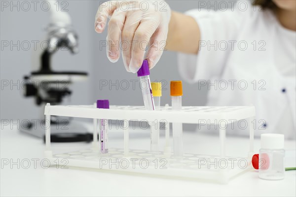 Girl scientist with test tubes lab coat