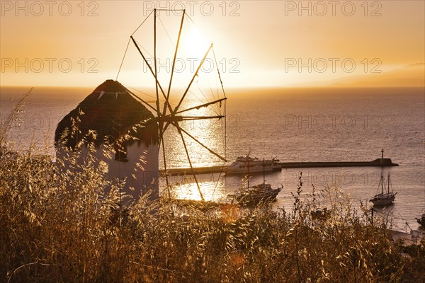 Golden sunset over sea horizon in Mykonos