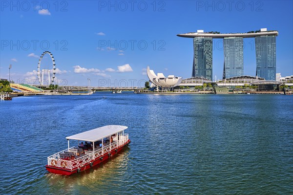 Tourist cruise boat approaching Marina Bay Sands