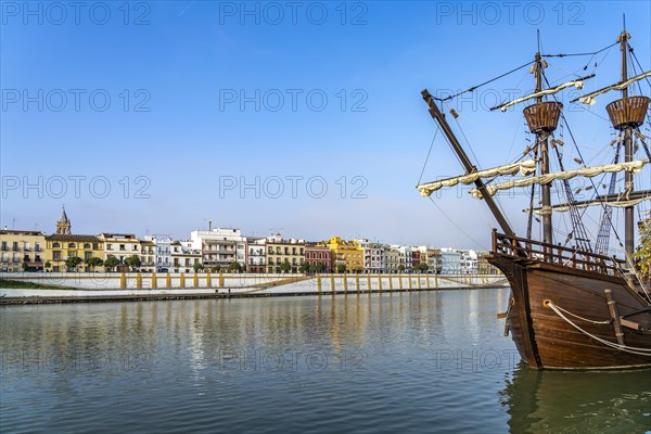 Replica of the Nao Victoria 500 and the colourful houses of the Triana district on the Guadalquivir River