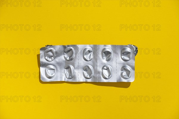 Empty tablet blister pack against a monochrome background