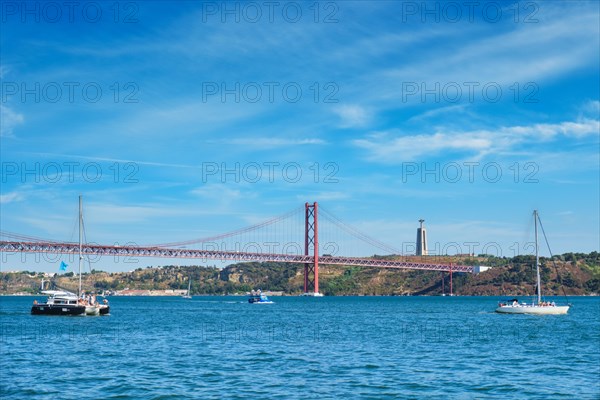 View of 25 de Abril Bridge famous tourist landmark over Tagus river
