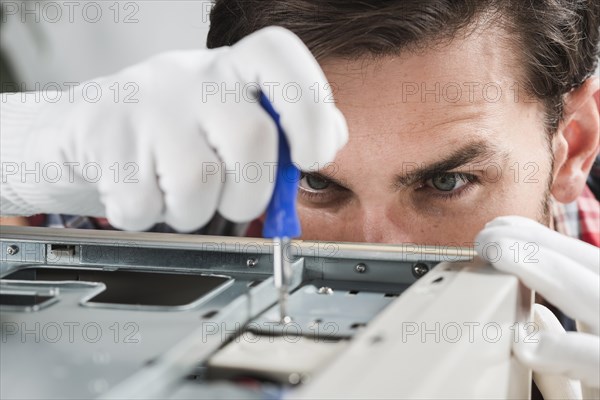 Male technician repairing cpu screwdriver