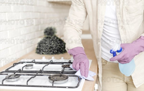 Man disinfecting stove