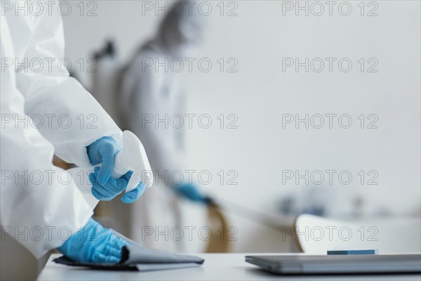 People disinfecting biohazard area