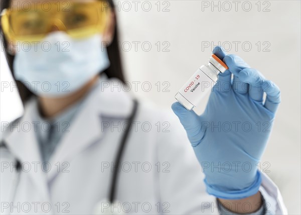 Doctor holding vaccine recipient her hand