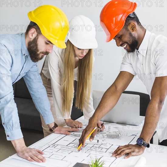 Group architect discussing layout plan blueprint office